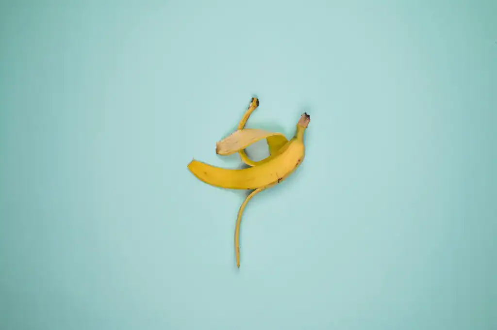 A vibrant banana peel on a pastel blue backdrop, perfect for fresh fruit concepts.