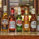 Collection of international beer bottles displayed on a bar counter.